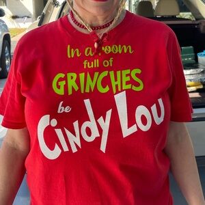 Large red t-shirt “IN A ROOM FULL OF GRINCHES, BE CINDY LOU